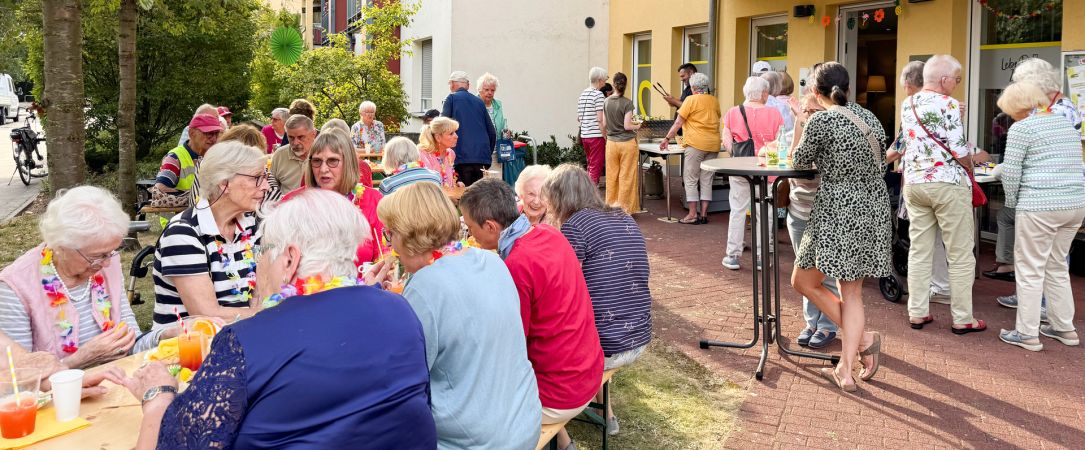 
                  Gemeinsam draußen sitzen beim Sommerfest